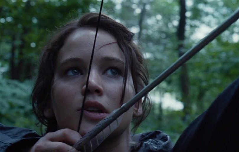 Katniss spänner en pilbåge.