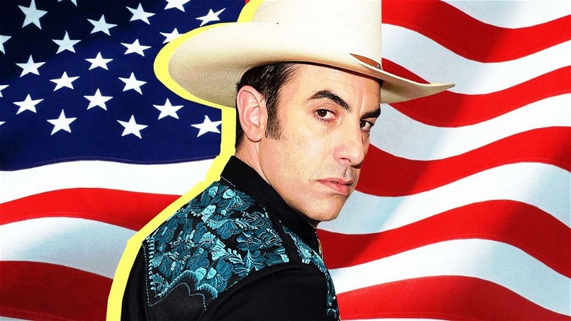 Sacha Baron Cohen står framför den amerikanska flaggan i en poster till Who Is America?.